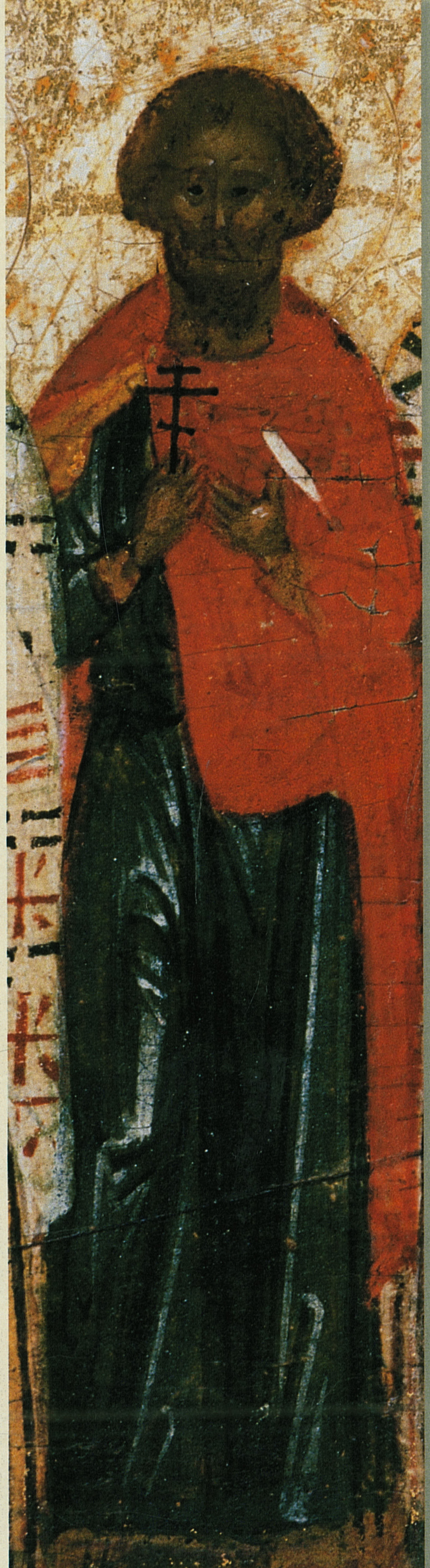 Narrow vertical icon panel showing a standing robed saint with a halo against a gold ground