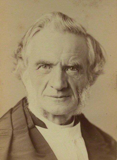 Black and white photograph of an elderly man with white hair and side whiskers, wearing a bishop's dress with white sleeves, seated