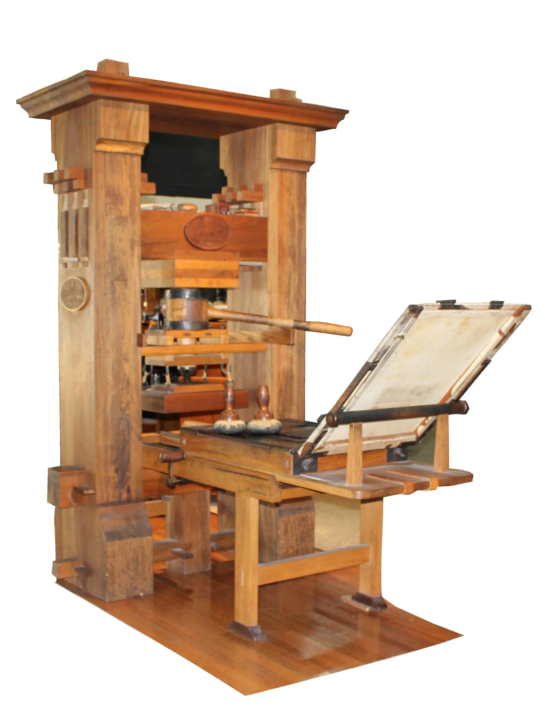 A wooden hand press with a large screw and a long pull lever, a replica of a fifteenth century printing press, in a museum room
