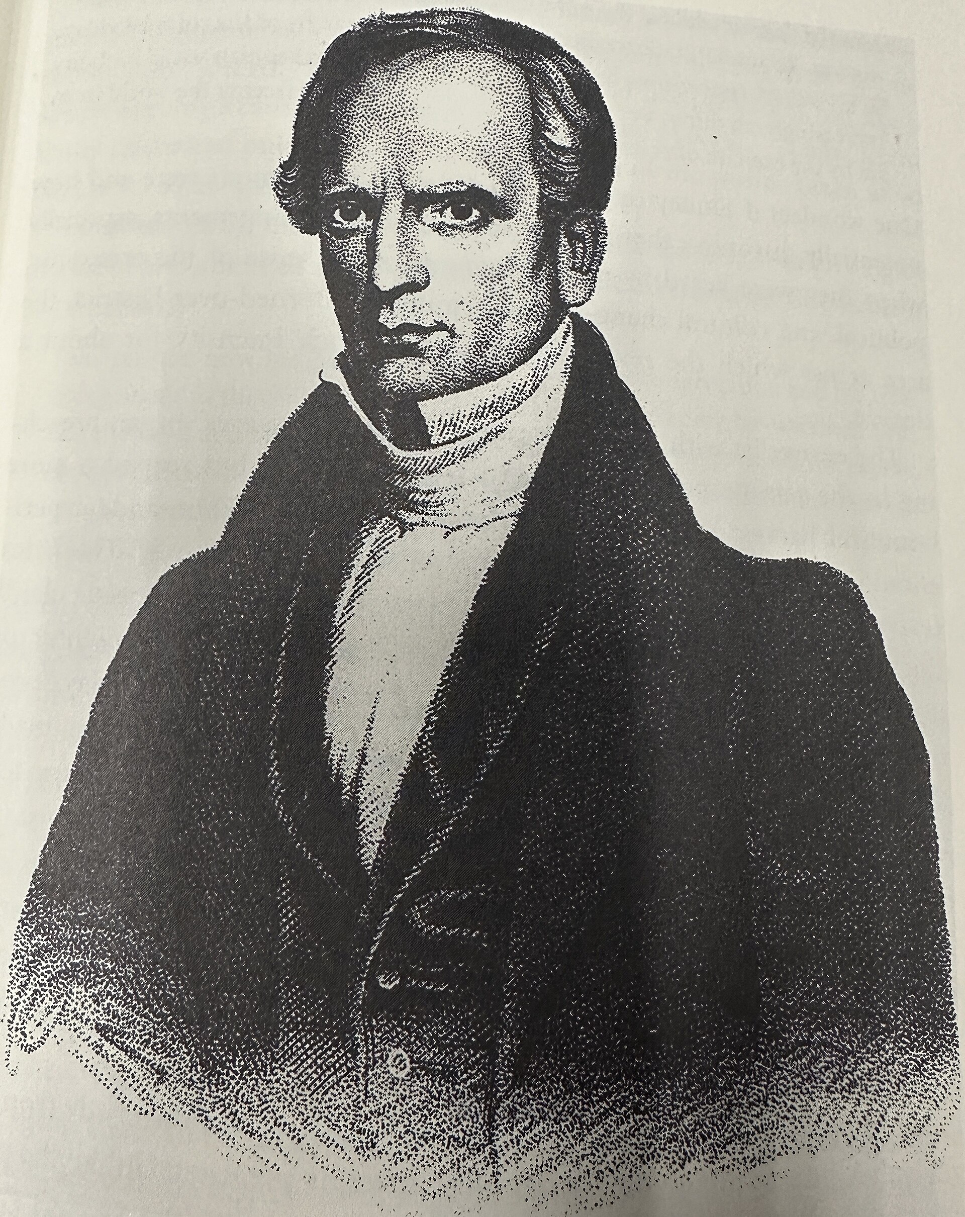 Portrait of a middle-aged man with a high forehead, swept-back hair and side whiskers, wearing a dark coat and white high collar, gazing intently at the viewer