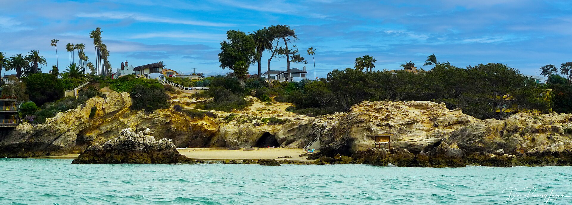 Wide view of the coastal cliffs at Corona del Mar above the beach and the Pacific Ocean