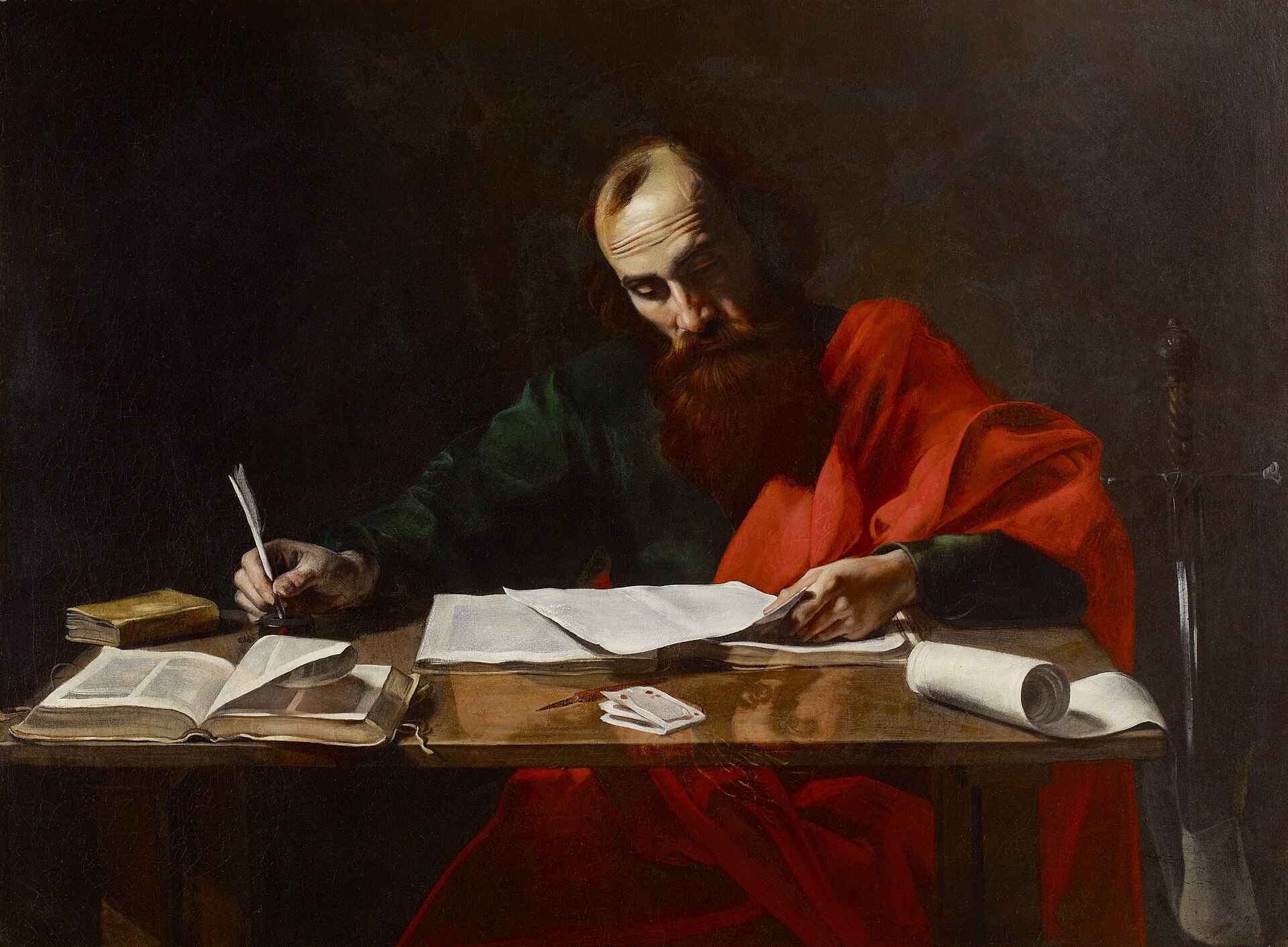 Painting of a bearded old man in a red cloak seated at a table, writing with a quill in a book, lit from one side against a dark background