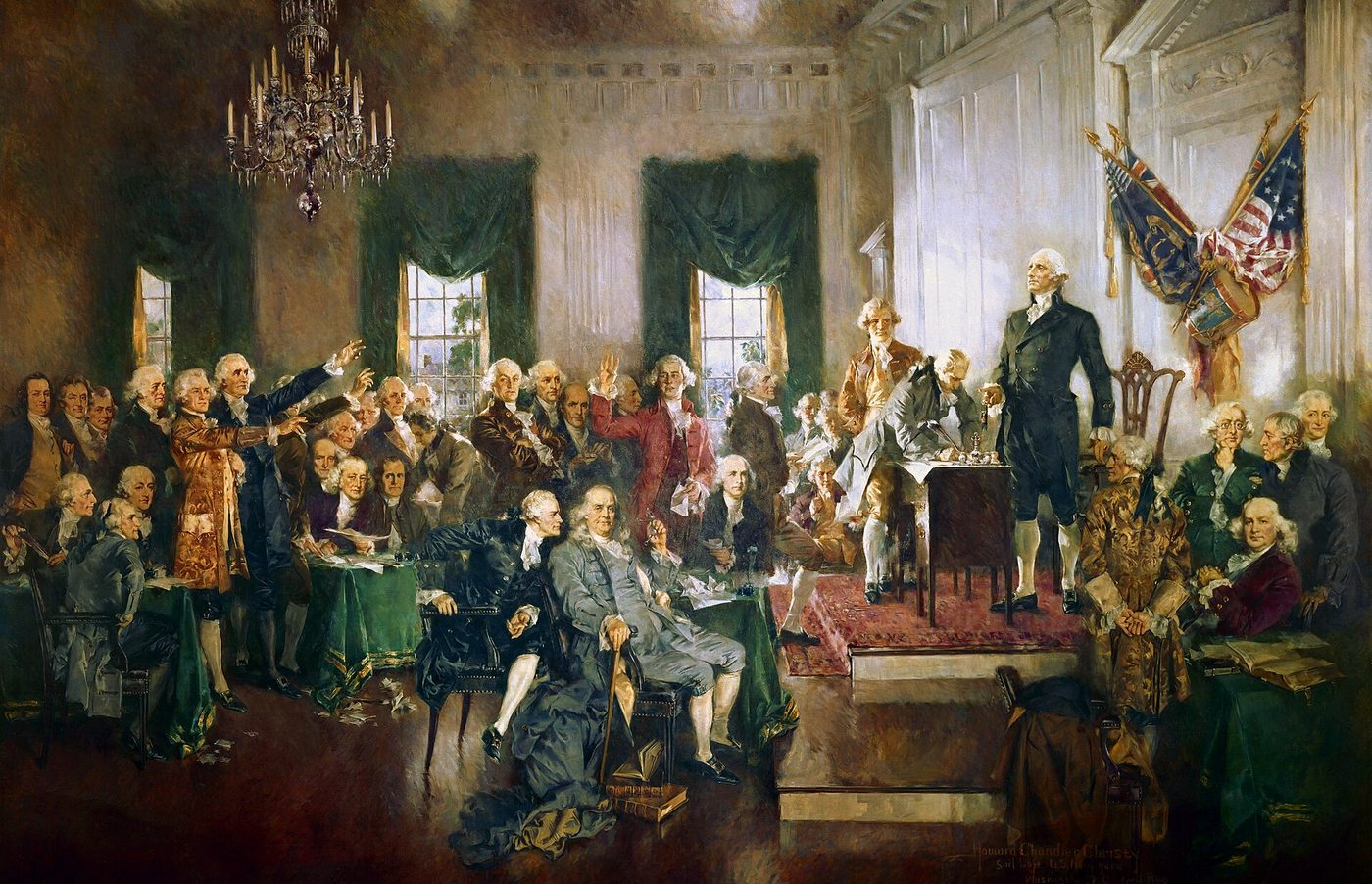 Large painting of the delegates gathered in Independence Hall, with George Washington standing on a raised platform at right and others signing at a table