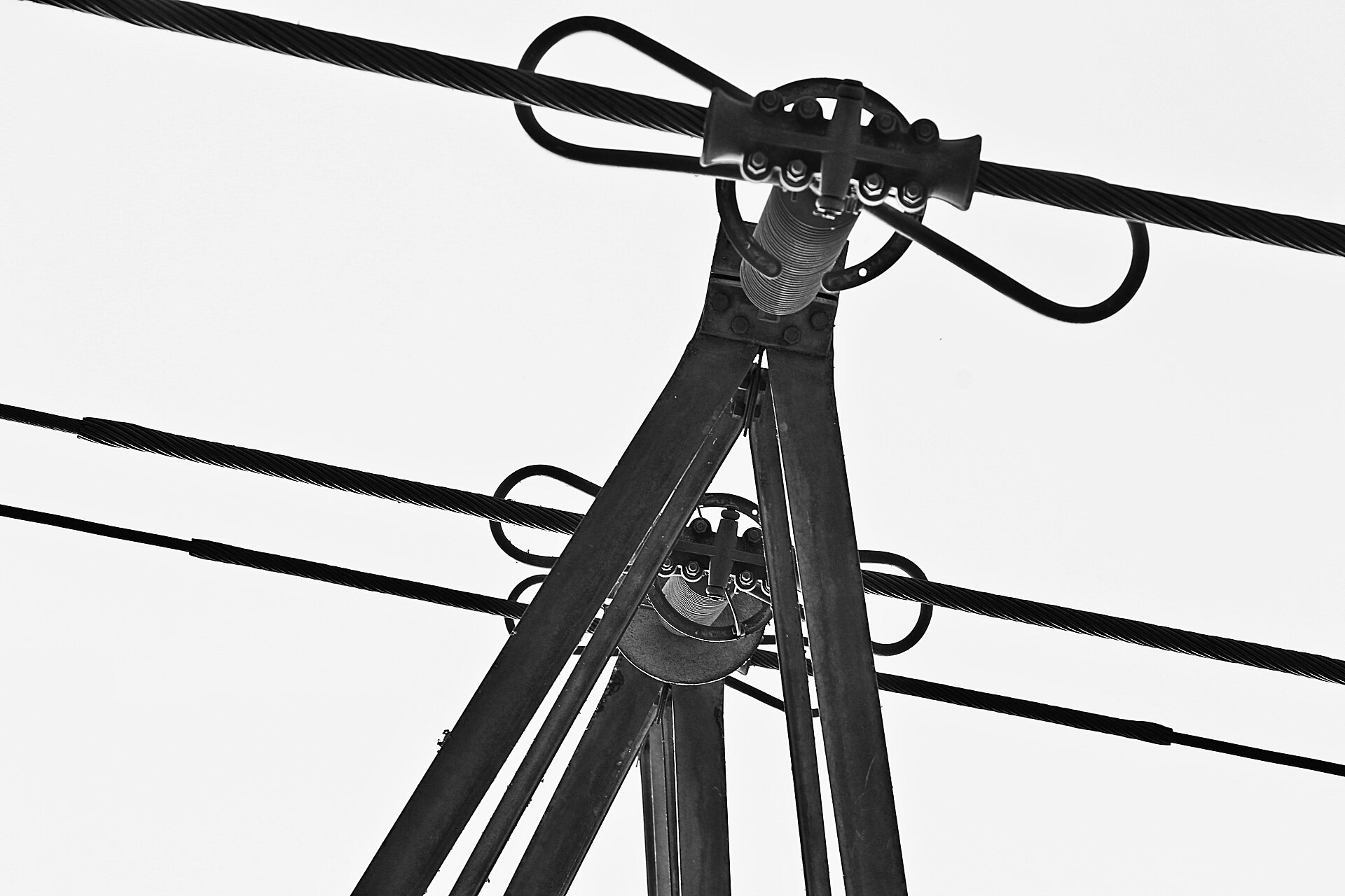Overhead high-voltage transmission lines strung between tall steel lattice towers.