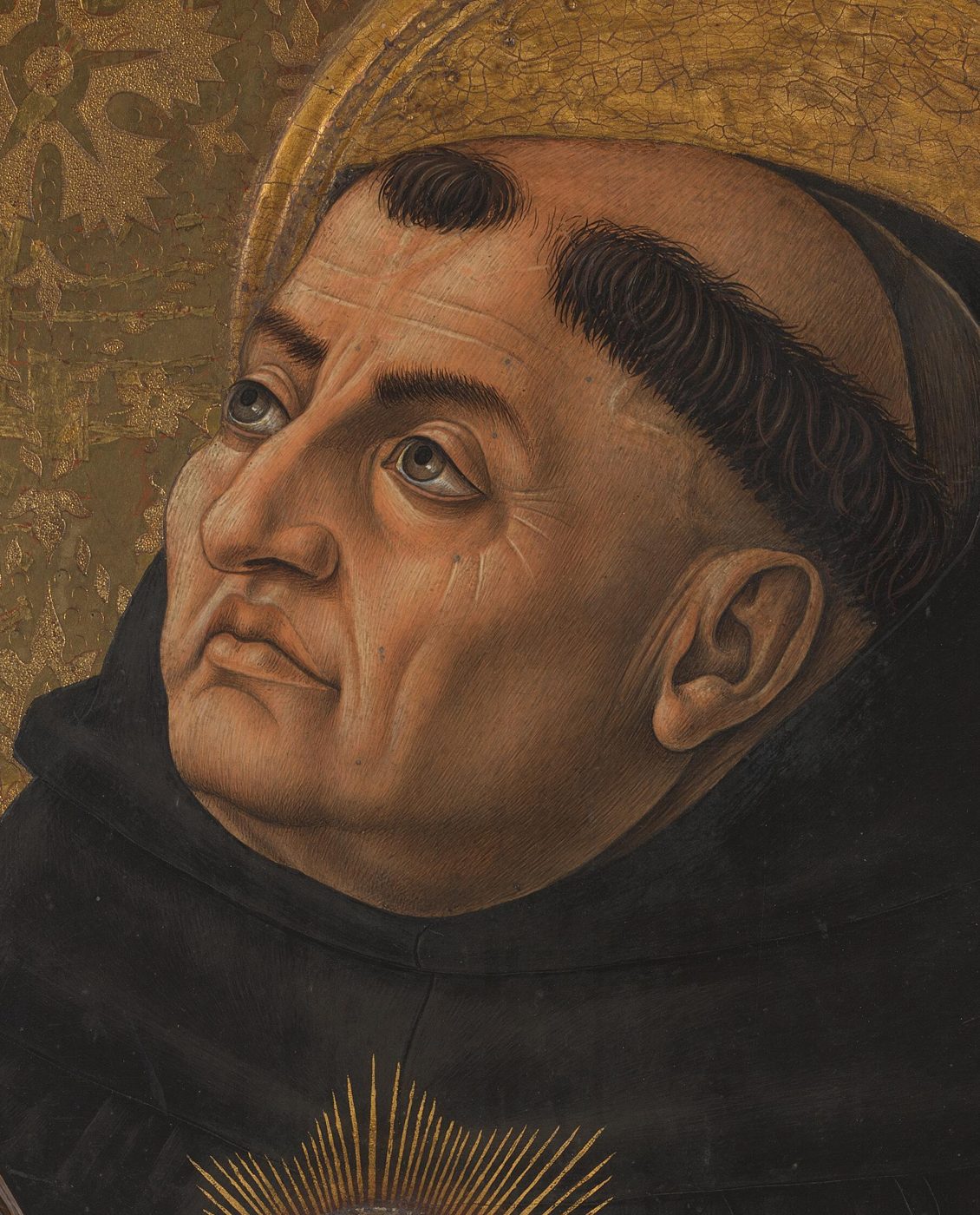 Saint Thomas Aquinas in Dominican habit holding a book and a model church, with a halo, painted in gold and rich color