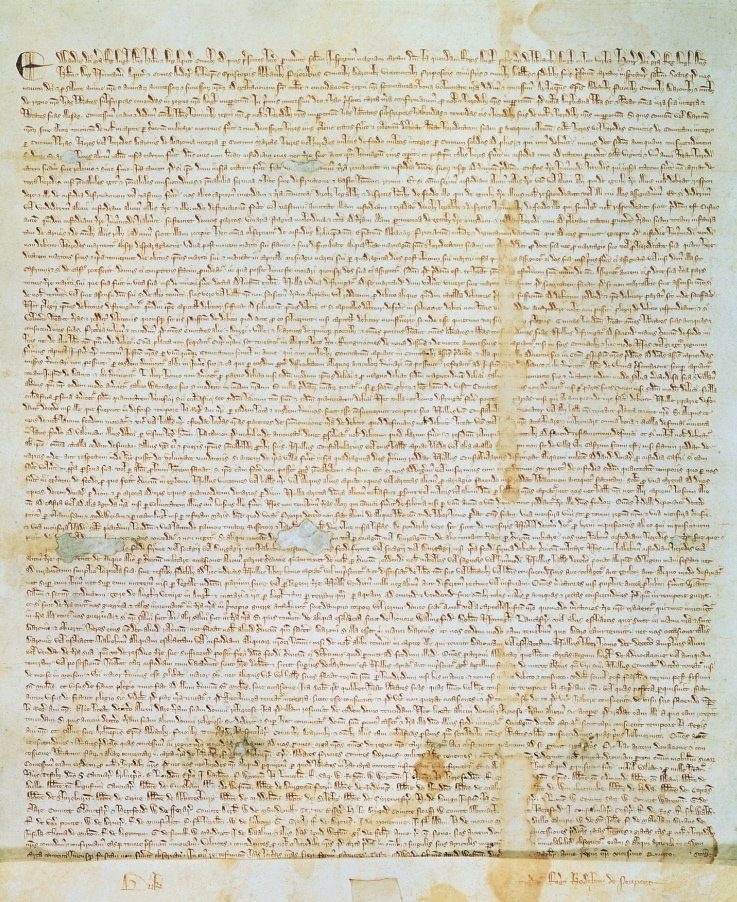 Photograph of a medieval parchment charter with dense Latin script and a hanging wax seal