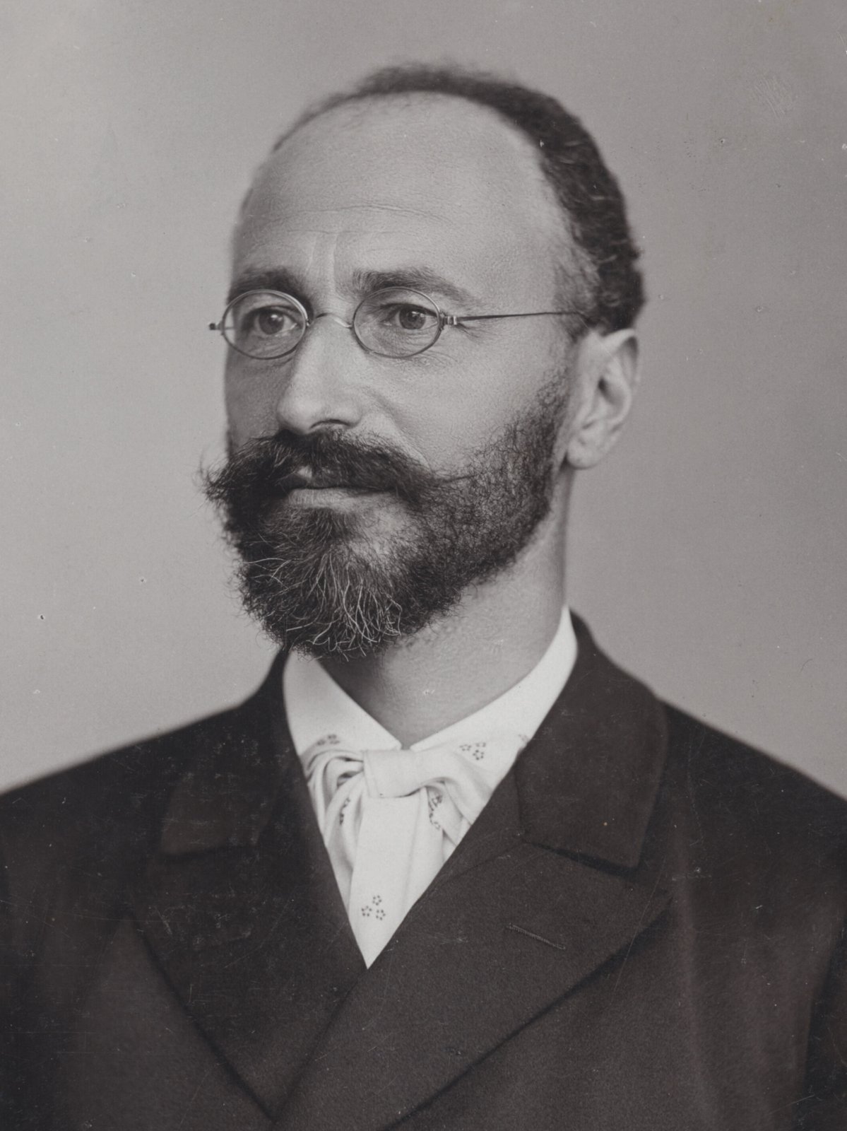 Studio portrait of Eugen von Bohm-Bawerk in 1896, with a full beard and a dark coat