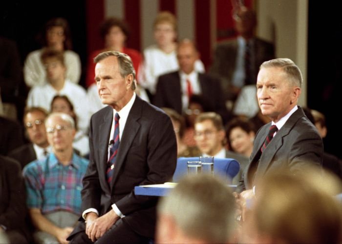 President George Bush and Ross Perot listening as Governor Bill Clinton answers a question at the town-hall debate in Richmond, Virginia