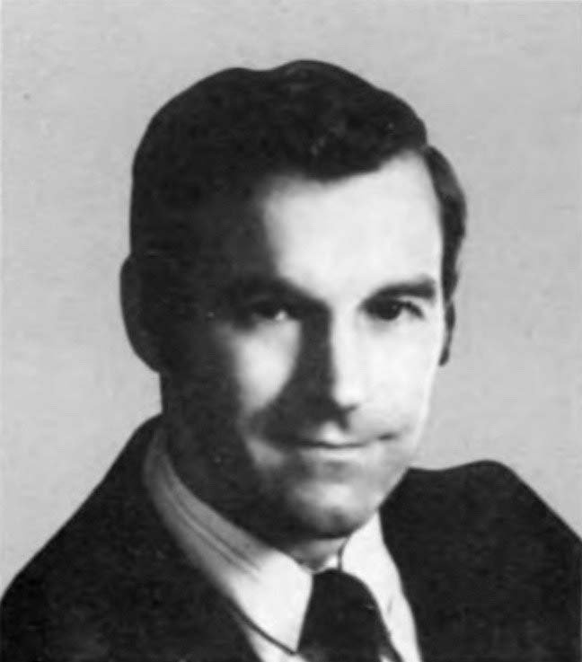 Small black and white head-and-shoulders photograph of a young Ron Paul in a suit and tie from the 1979 congressional directory