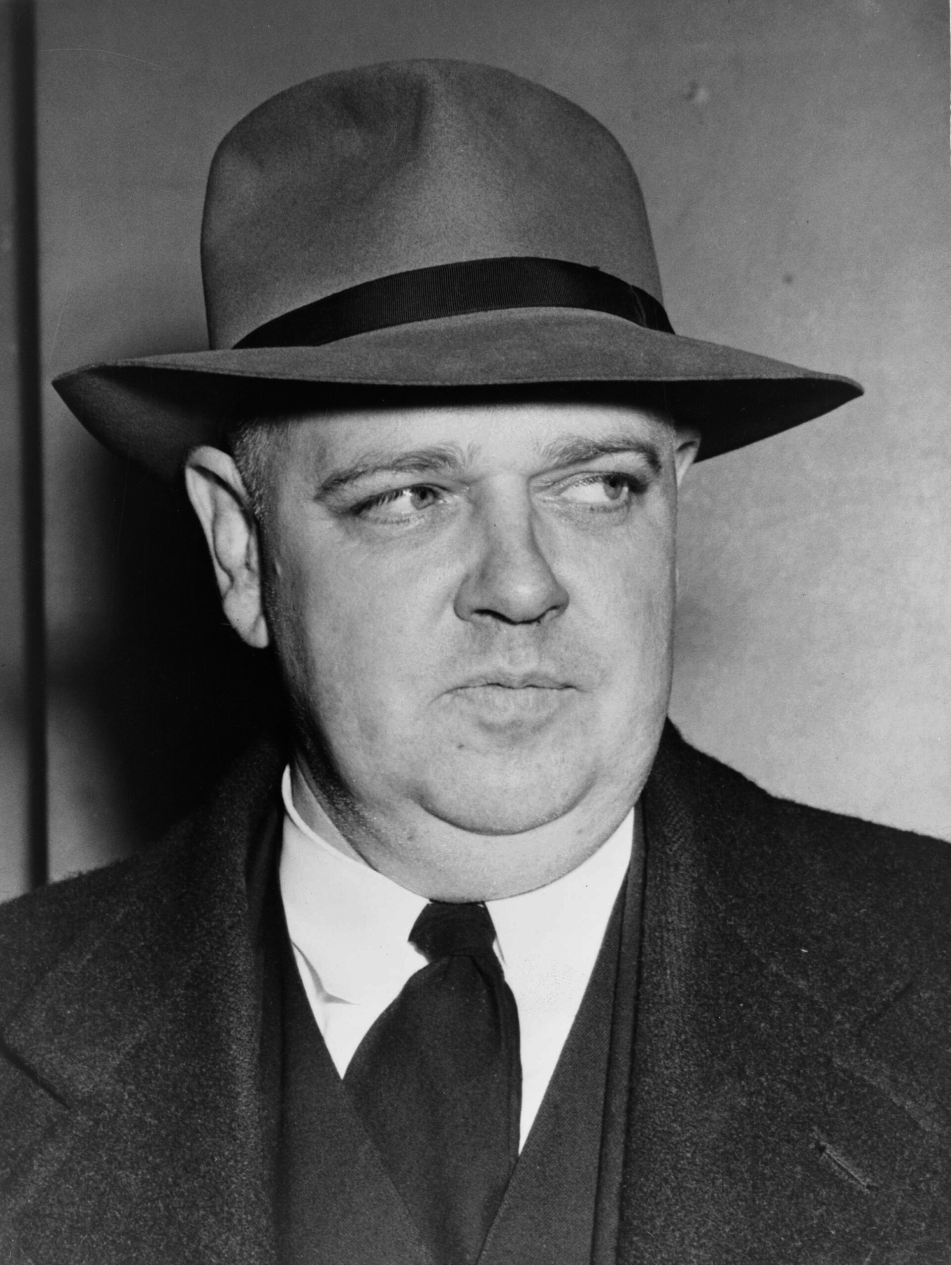 Black and white photograph of a man in a suit