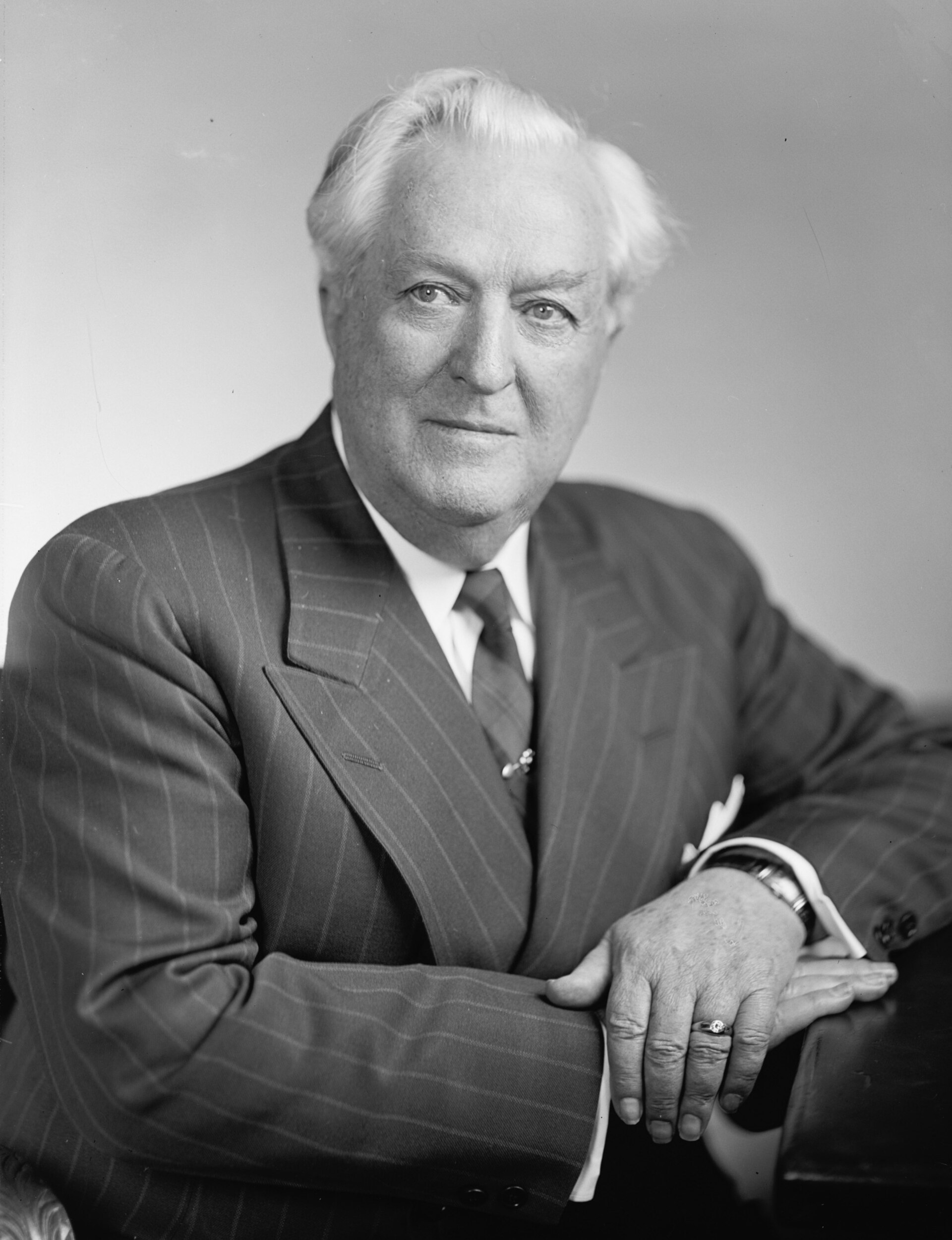Formal portrait photograph of a man in a suit
