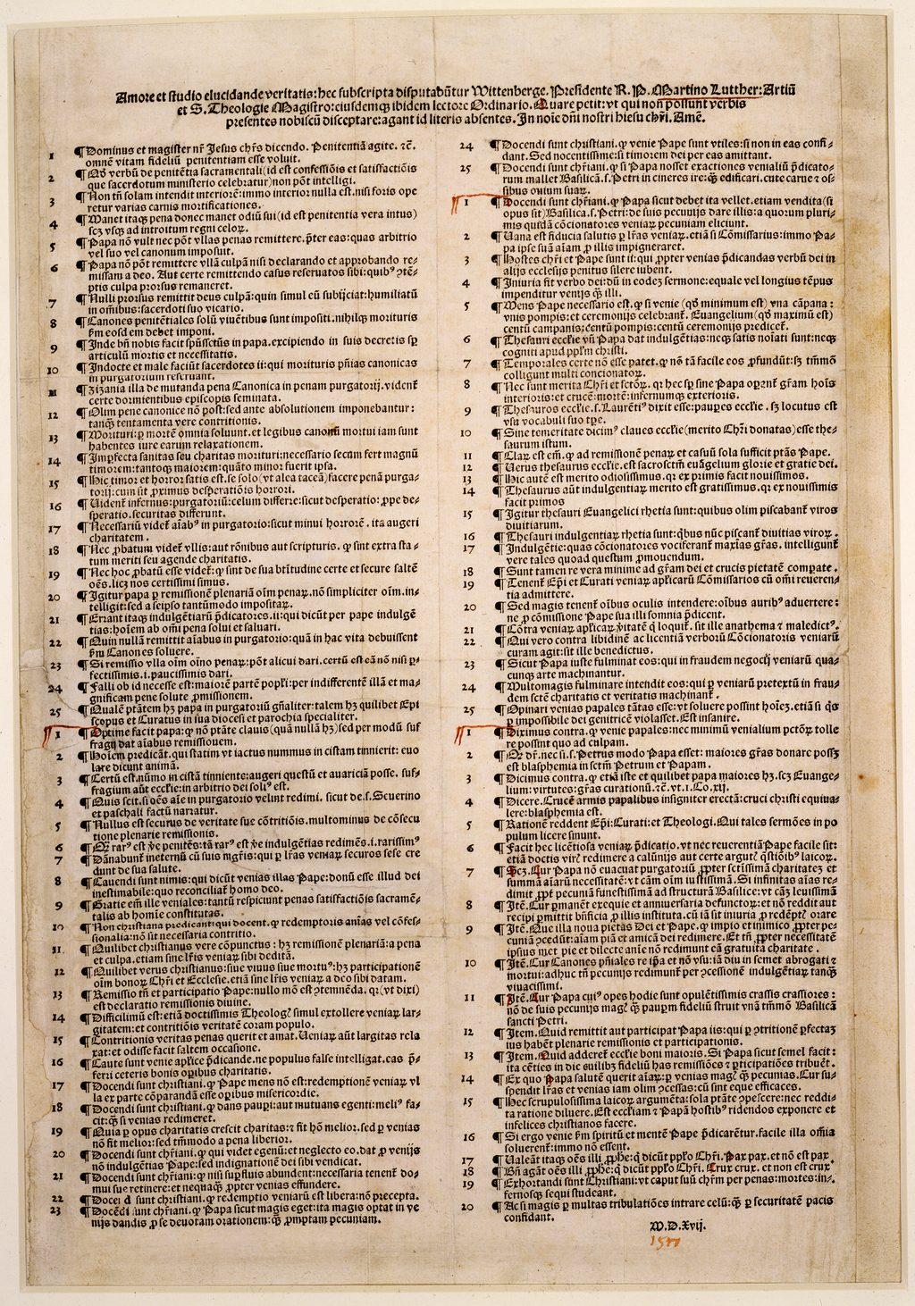 A printed broadsheet in Latin with dense black type in two columns of numbered paragraphs, under a long heading, with a few handwritten red marks in the margins