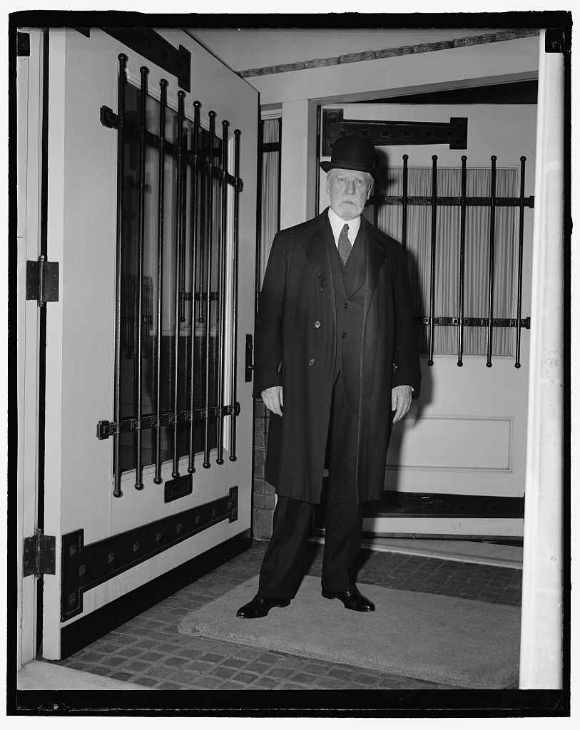 Black and white portrait of an elderly man with a full white beard wearing a judicial robe