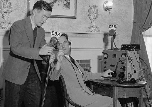 Two radio engineers setting up broadcast equipment in a living room in 1937
