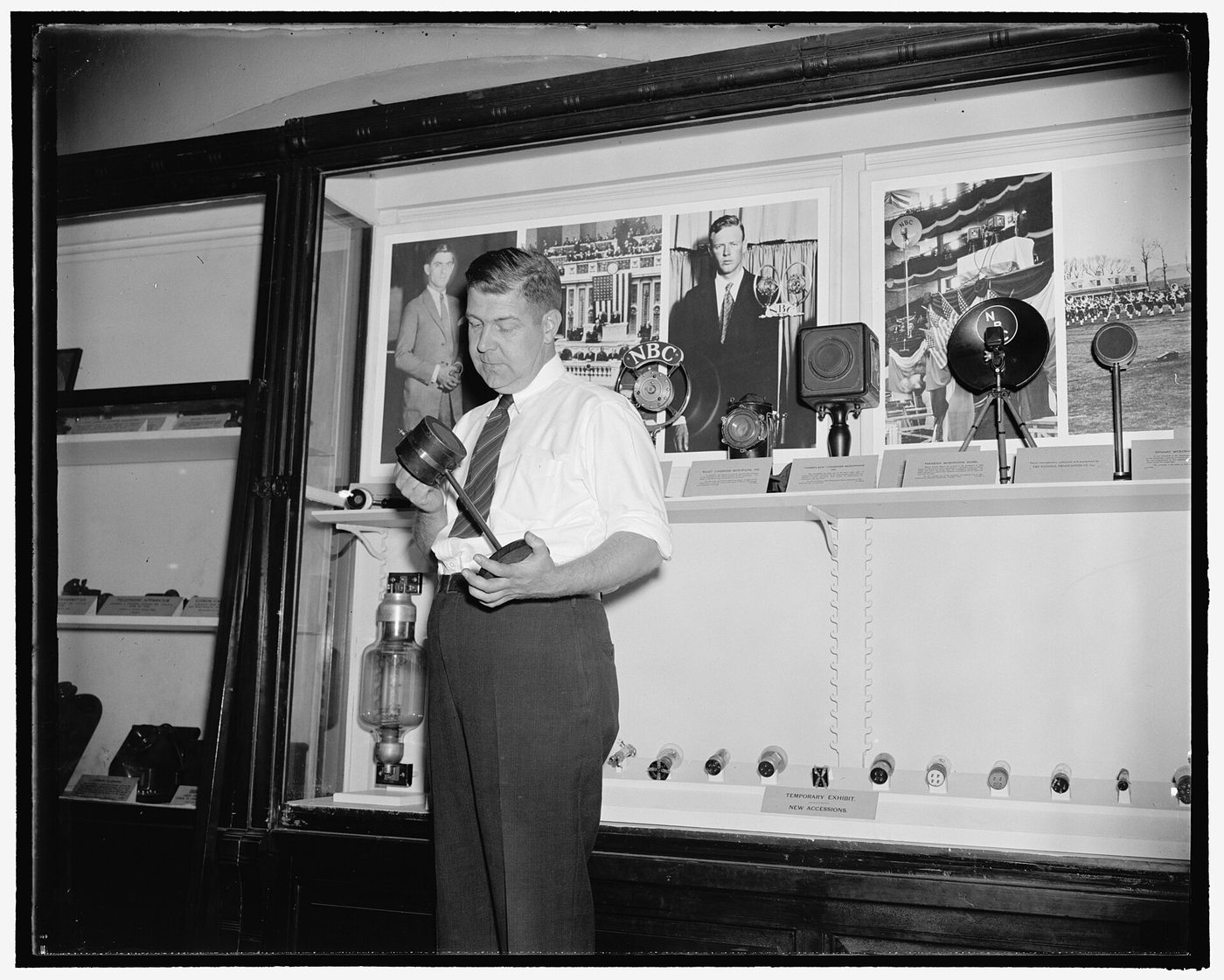 Early carbon radio microphone shaped like a tin can, displayed in 1938