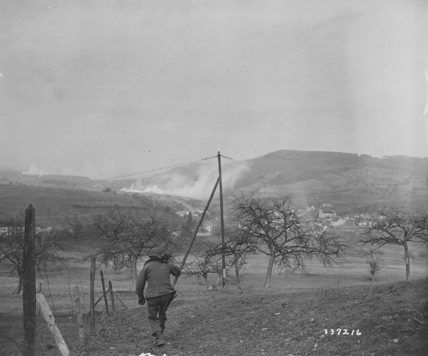 Army cameraman in winter gear carrying a motion picture newsreel camera