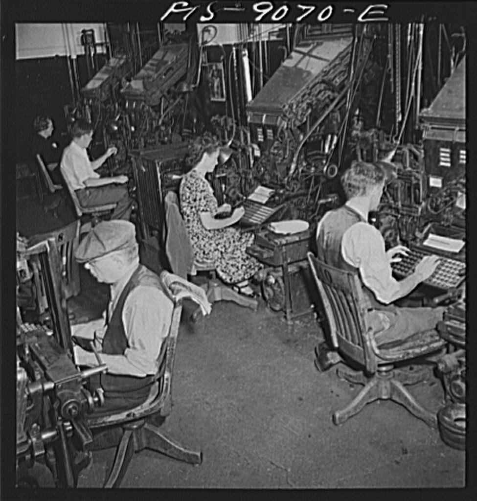 Linotype operators at their machines in a newspaper composing room
